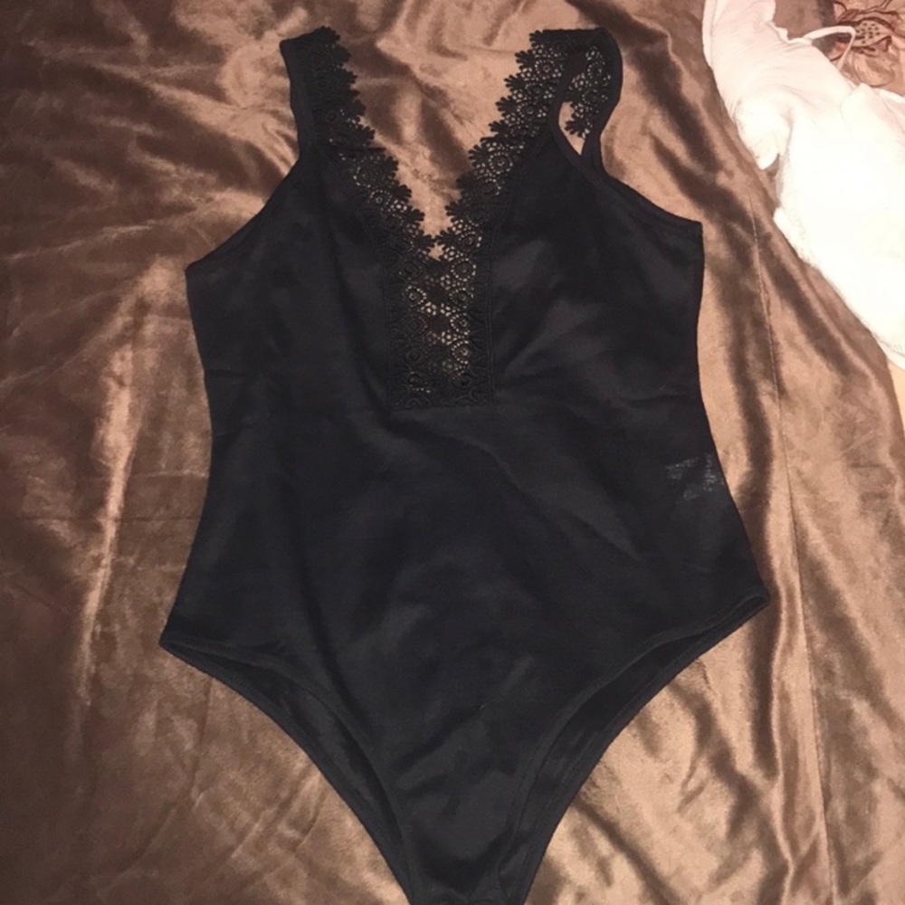 Black H&M Bodysuit top with lace trim. Tried on but never worn out.